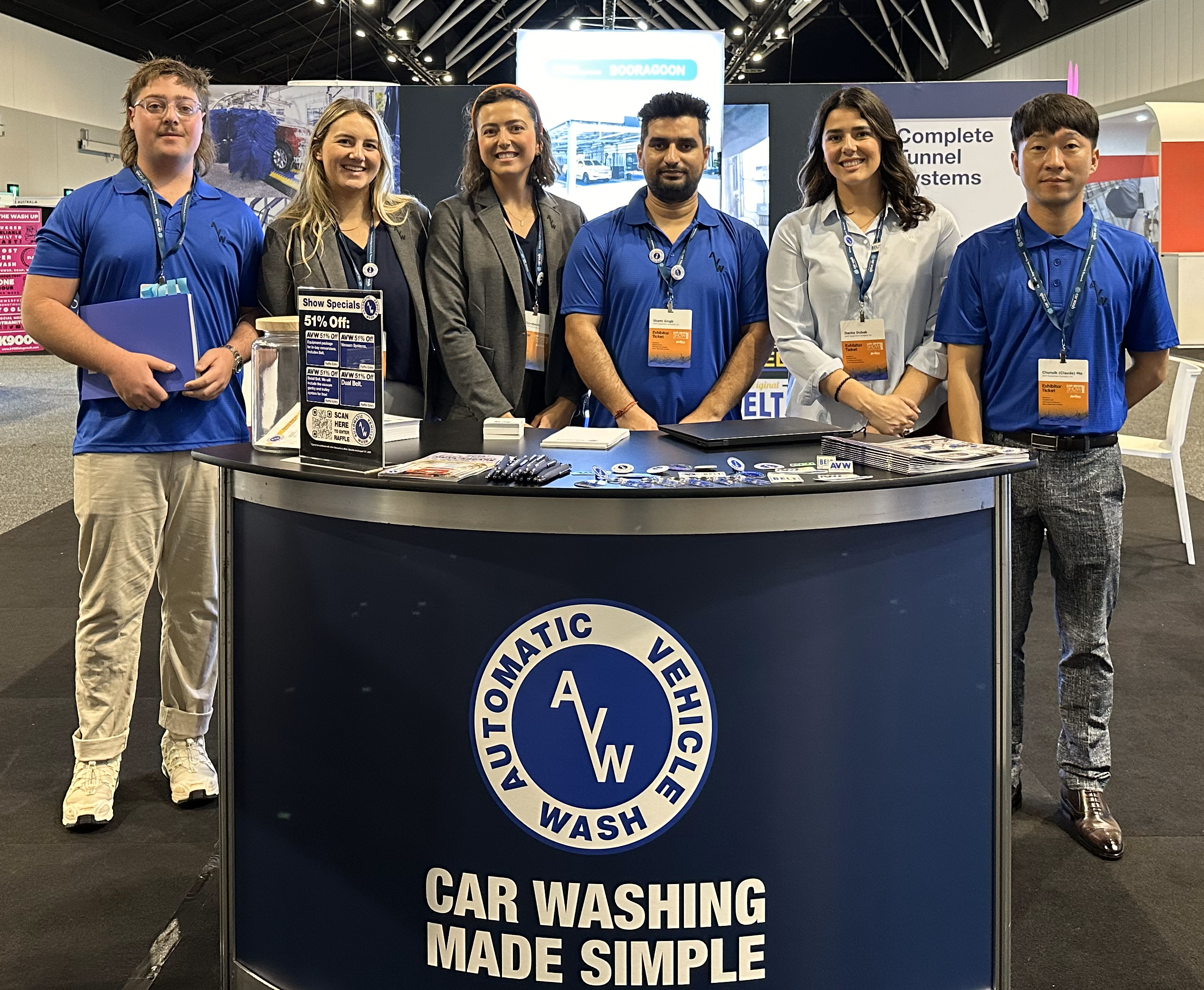 Team of professionals at the AVW booth showcasing car washing equipment and solutions at the Australia 2024 trade show, with a focus on customer service and innovation